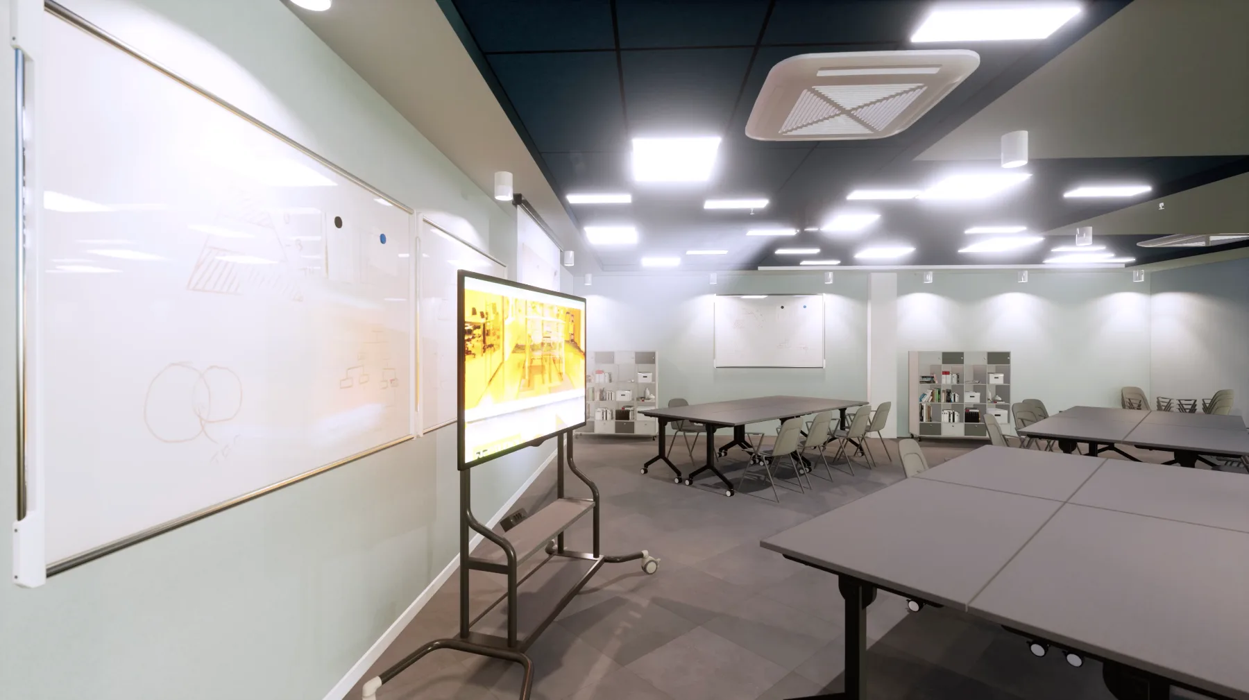 Sala de aula flexível com lousas de vidro, monitor móvel e mesas dobráveis sobre rodízios